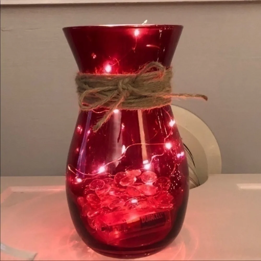 Red vase with string fairy lights